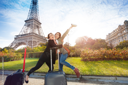 Two happy friends meeting in Paris