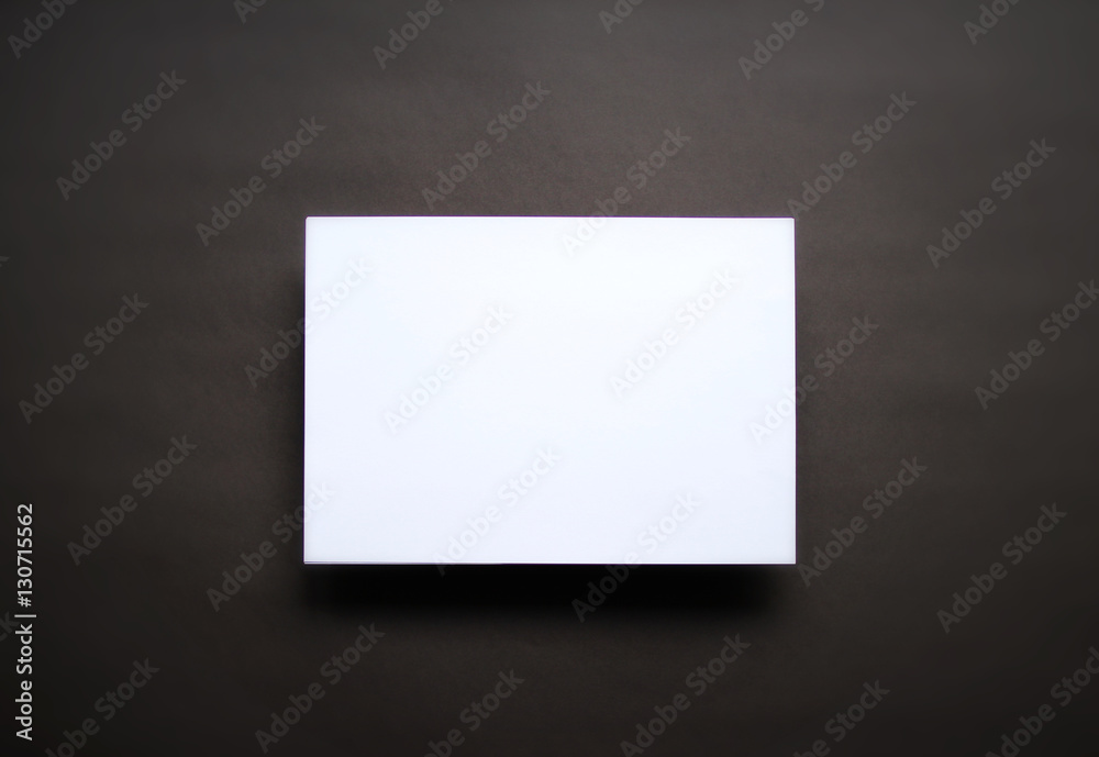 Empty white paper sheet dark brown background Empty white paper sheet dark brown background