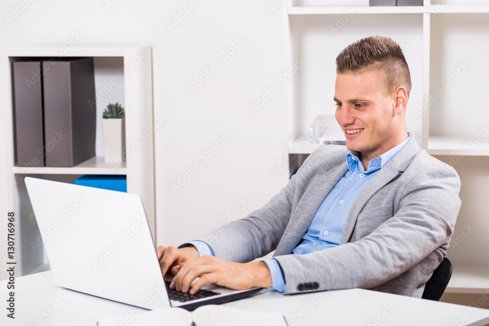 Businessman sitting in his office and using laptop. Businessman sitting in his office and using laptop.