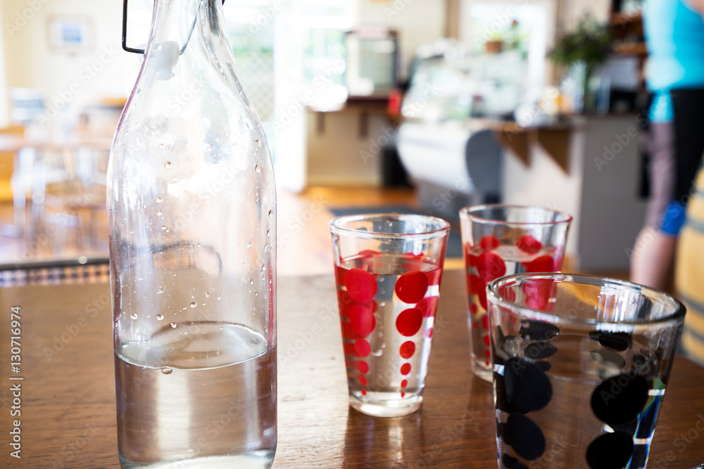glasses and bottle with water on table glasses and bottle with water on table