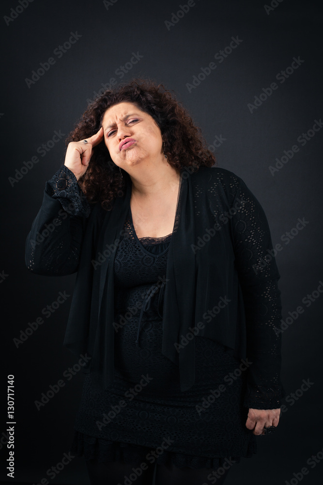 Beautiful woman doing different expressions in different sets of clothes: headache Beautiful woman doing different expressions in different sets of clothes: headache