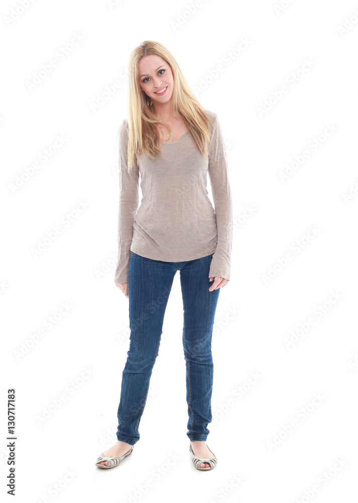 full length portrait of pretty blonde girl wearing casual brown shirt and jeans. standing pose isolated against white background full length portrait of pretty blonde girl wearing casual brown shirt and jeans. standing pose isolated against white background