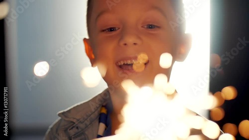 Smiling boy holding fireworks