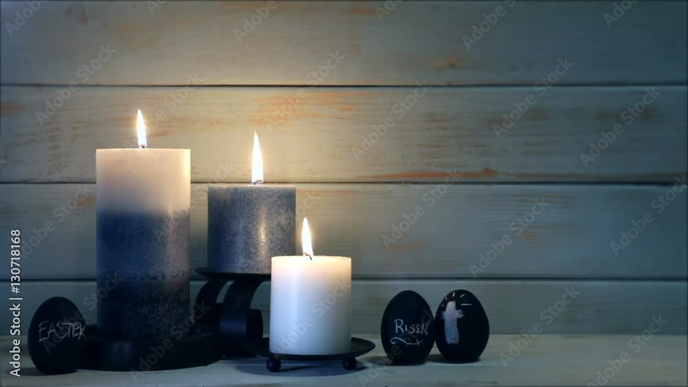 This is a video of blue candles on a urban peeling wood background with copy space for religious and holiday concepts