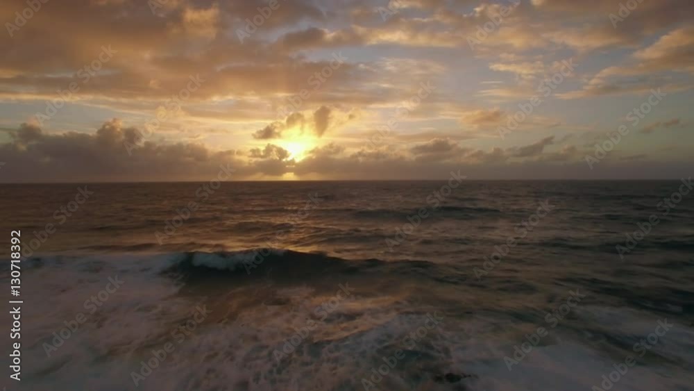 Aerial close up view of water waves with foam near strand in Indian Ocean against sunset and sky with pink clouds, Mauritius Island Aerial close up view of water waves with foam near strand in Indian Ocean against sunset and sky with pink clouds, Mauritius Island