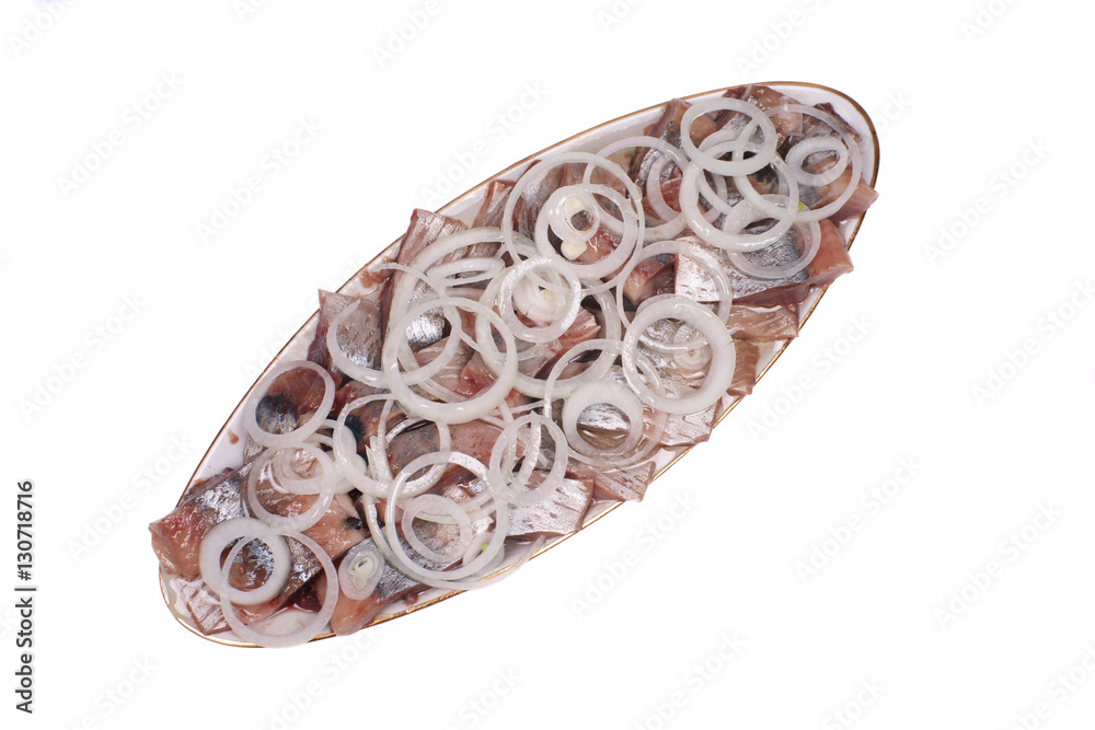 oval dish with herring and onion on a white background oval dish with herring and onion on a white background