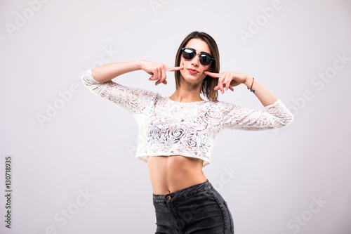 portrait of cheerful fashion hipster girl going crazy in casual hipster clothes isolated on white