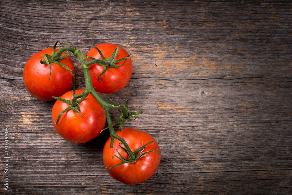 Bunch of tomatoes on the wooden table in natural light Bunch of tomatoes on the wooden table in natural light