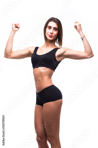 Full length of young beautiful woman in sportswear doing exercises while white background