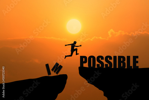 Man jumping over impossible or possible over cliff on sunset background,Business concept idea