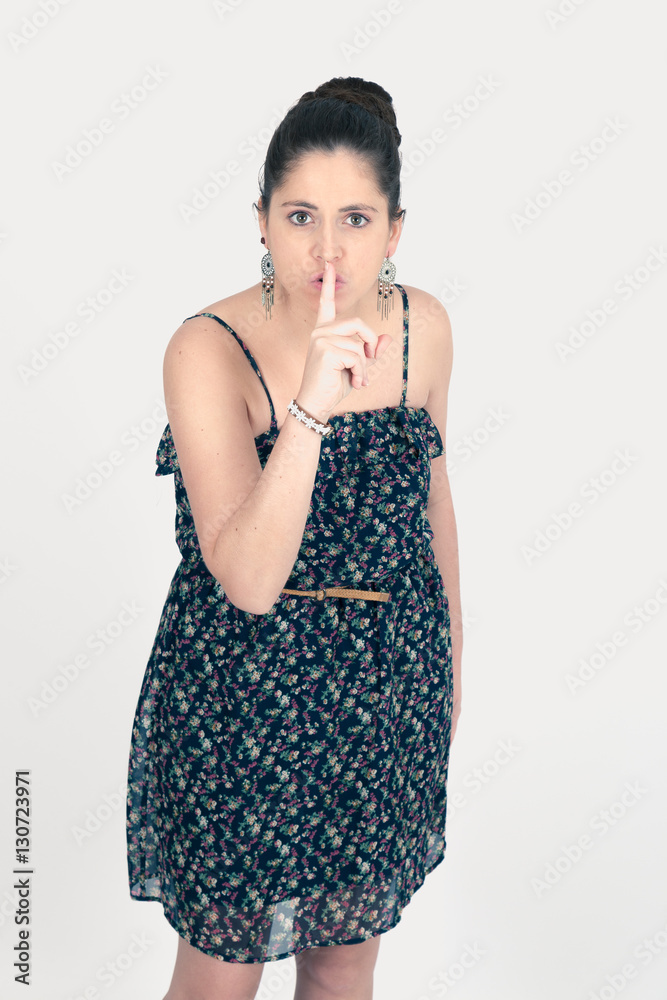 Beautiful woman doing different expressions in different sets of clothes: be quiet Beautiful woman doing different expressions in different sets of clothes: be quiet