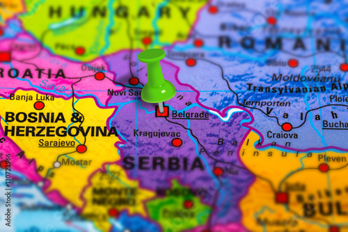 Belgrade in Serbia pinned on colorful political map of Europe. Geopolitical school atlas. Tilt shift effect.