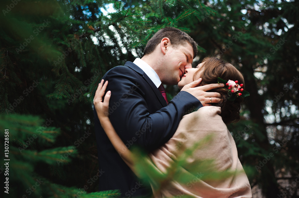 Bride and groom hugging in a forest in the autumn forest, weddin Bride and groom hugging in a forest in the autumn forest, weddin