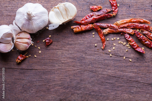 garlic and dried chilli on wooden background