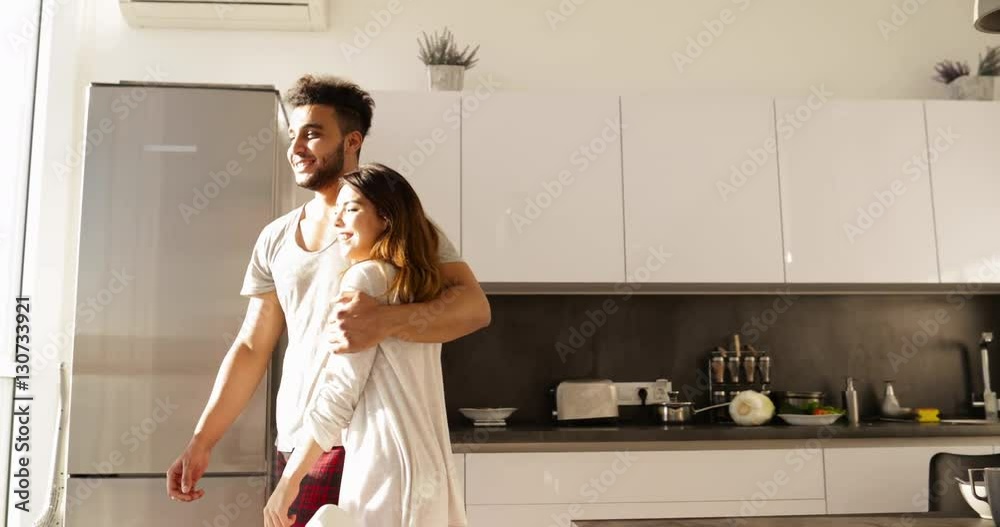 Young Mixed Race Couple In Kitchen Morning Sunlight, Cute Happy Hispanic Man Asian Woman Hold Hands Slow Motion Young Mixed Race Couple In Kitchen Morning Sunlight, Cute Happy Hispanic Man Asian Woman Hold Hands Slow Motion