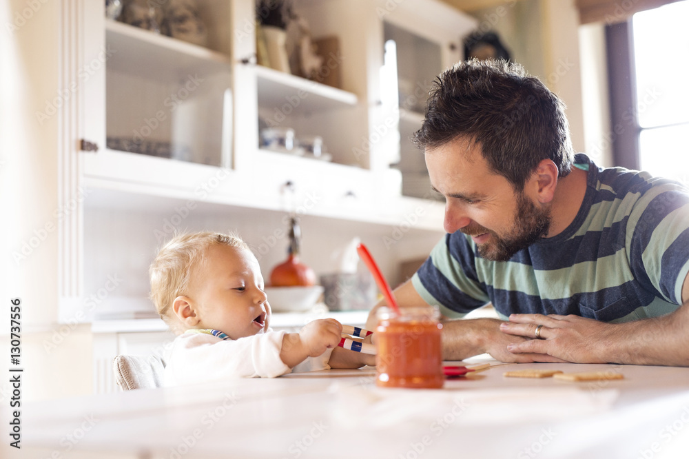 Father and baby at home at dining table Father and baby at home at dining table
