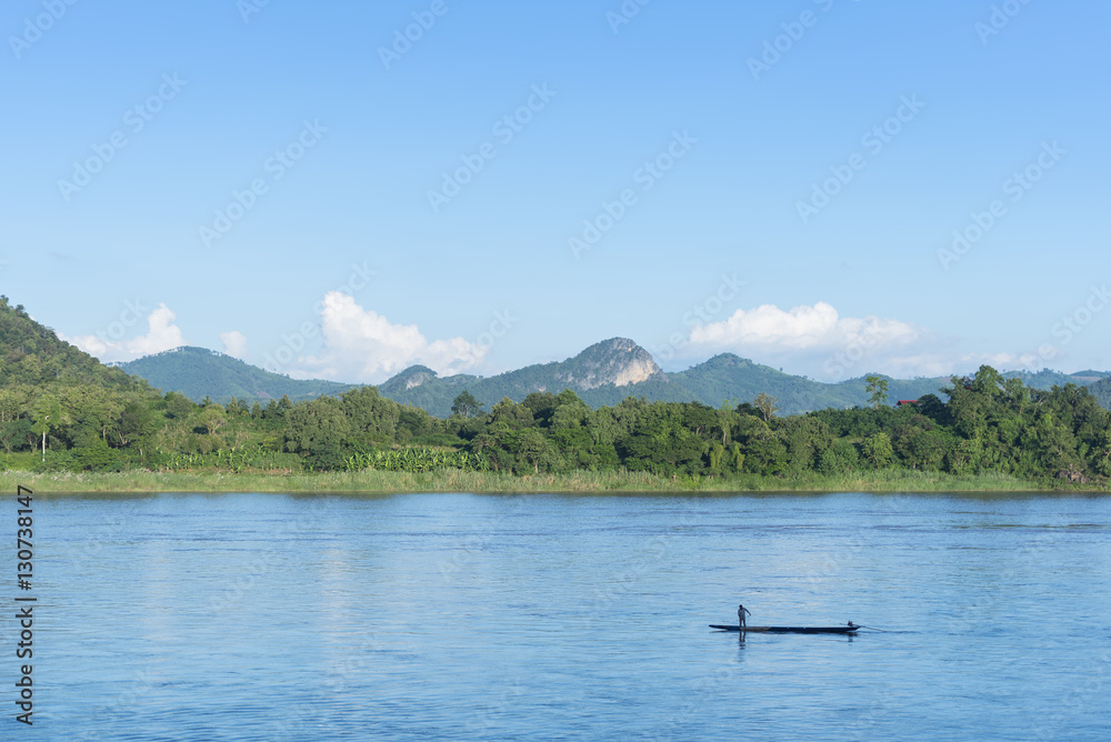 Fisherman in the River in a Small Boat, Loei, Thailand Fisherman in the River in a Small Boat, Loei, Thailand