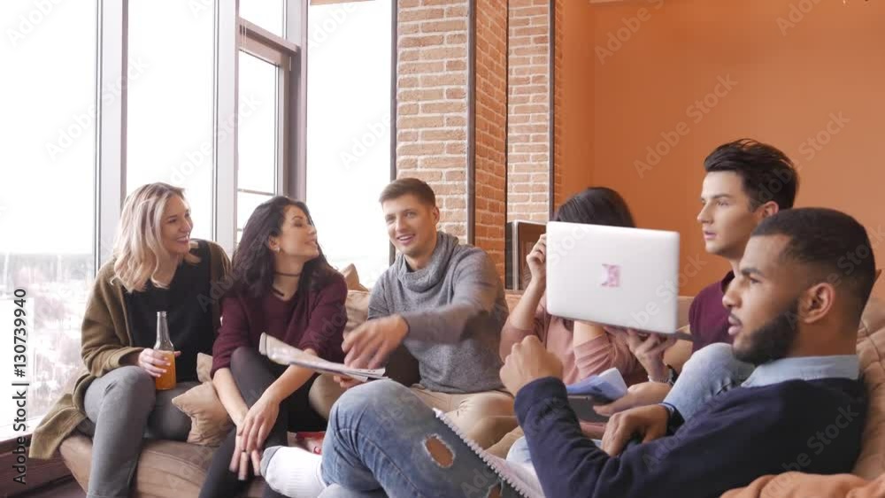 Group of multi ethnic young students having fun to preparing for exams in home interior Group of multi ethnic young students having fun to preparing for exams in home interior