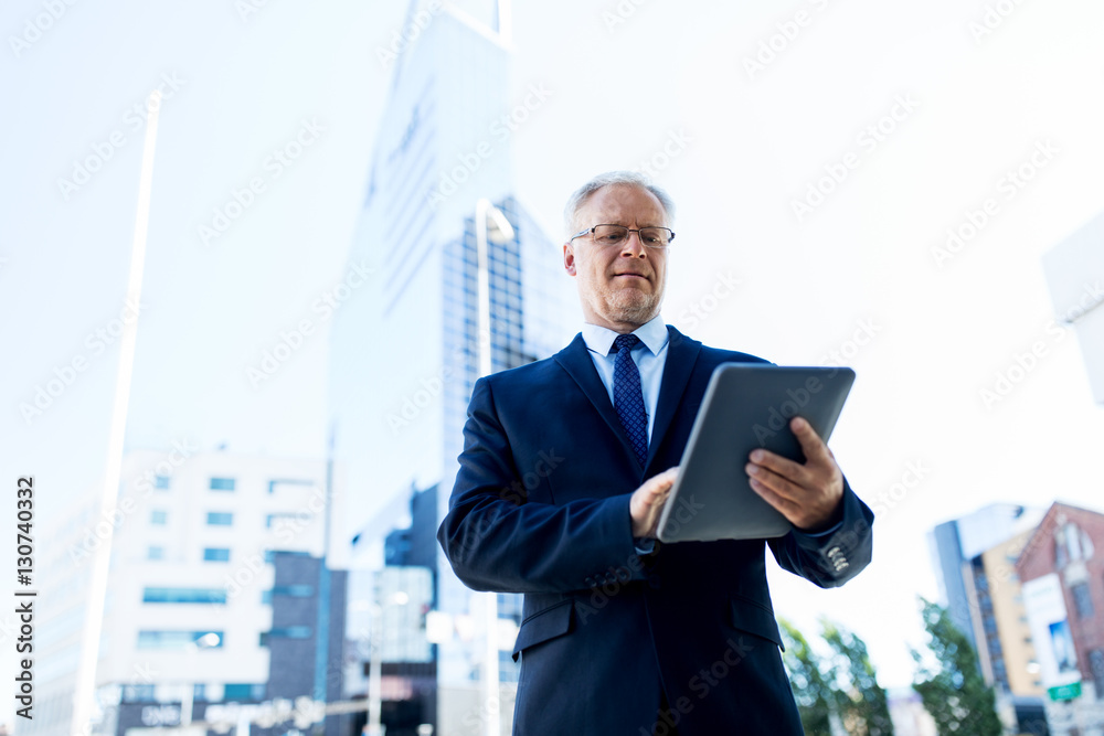 senior businessman with tablet pc on city street senior businessman with tablet pc on city street