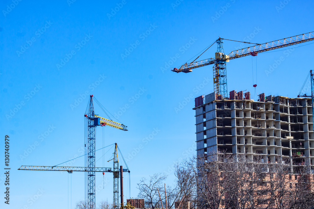 close up picture of building in progress with tower cranes close up picture of building in progress with tower cranes