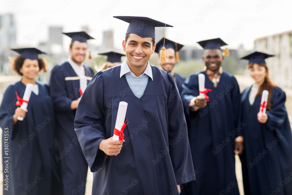 happy students in mortar boards with diplomas happy students in mortar boards with diplomas