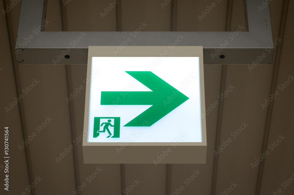 green emergency exit sign showing the way to escape. green emergency exit sign showing the way to escape.
