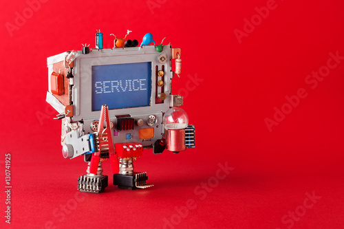 Service center and repairing concept. Tv robot handyman with pliers and light bulb in hands. Warning message service on blue screen monitor head. red background copy space