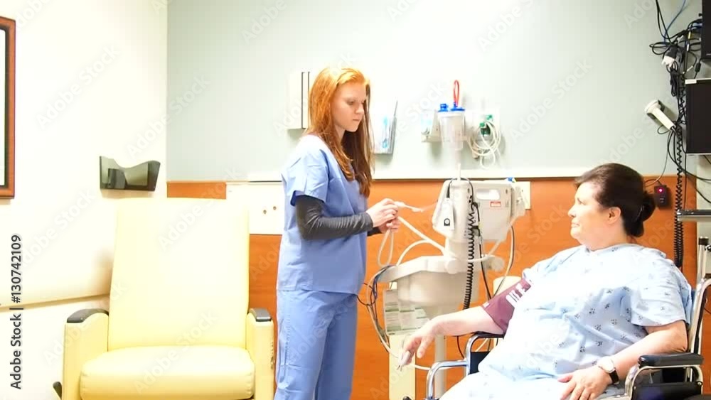 female nurse with patient ejecting thermometer cover.
female nurse with patient ejecting thermometer cover.