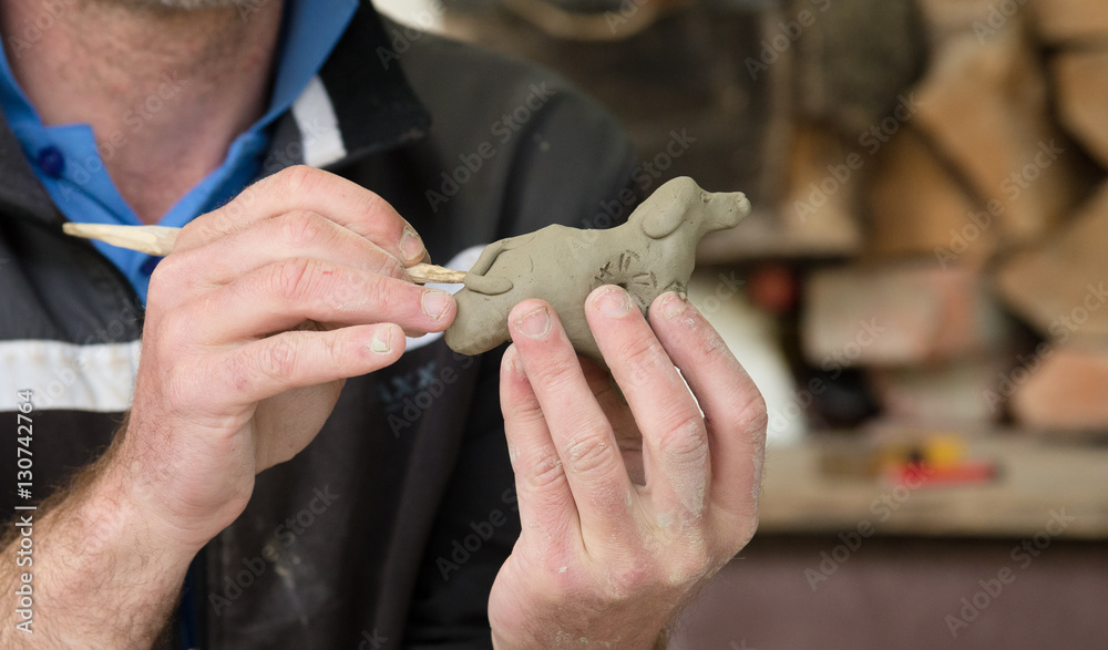 Sculptor clinging figure of clay Sculptor clinging figure of clay