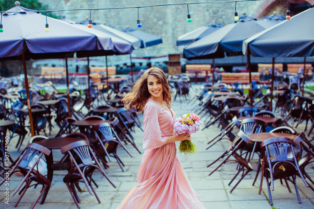 The charming lady keeps a bouquet