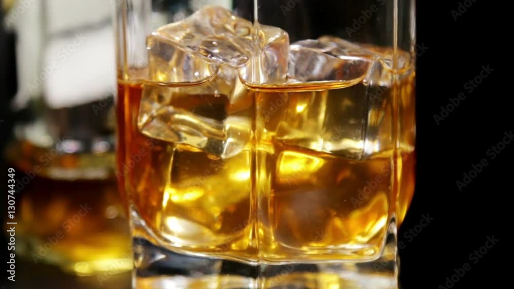 glasses of malt whiskey on a black table. video slider glasses of malt whiskey on a black table. video slider