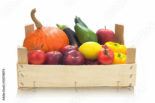 Colorful assortment organic Vegetables and red Apples Grown with natural in Wooden crate isolated on white