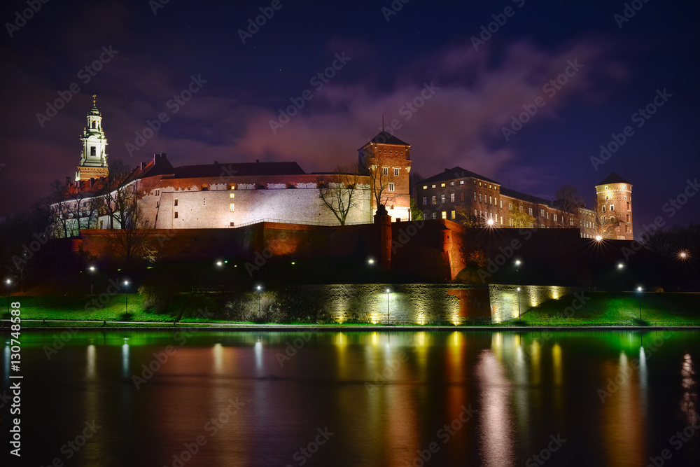 Night view of Wawel castle located at Vistula river in Cracow. P