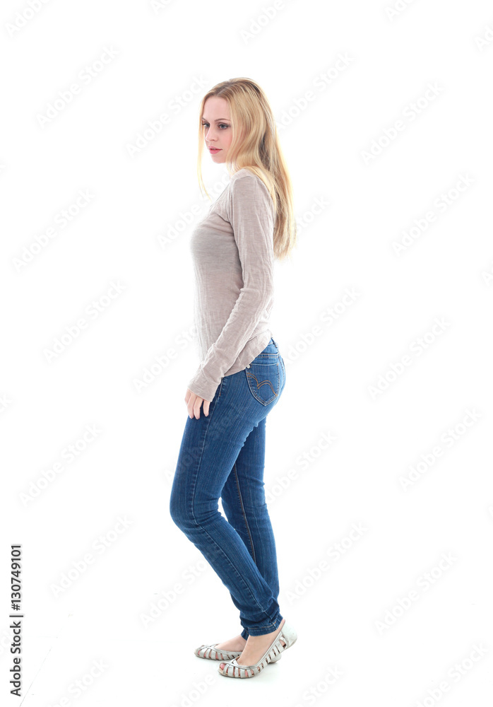 full length portrait of pretty blonde girl wearing casual brown shirt and jeans. standing pose isolated against white background full length portrait of pretty blonde girl wearing casual brown shirt and jeans. standing pose isolated against white background