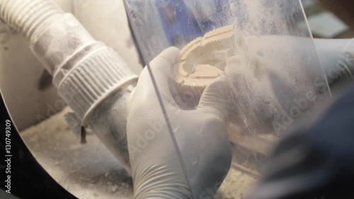 Close-up of ceramet implant creature process at laboratory. Technician creating a model of jaw with gipsum for create ceramet implant. photo