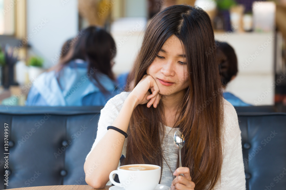 Happy asian female with latte coffee in cafe during free time