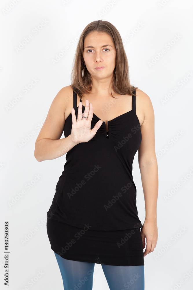 Beautiful woman doing different expressions in different sets of clothes: stop sign Beautiful woman doing different expressions in different sets of clothes: stop sign