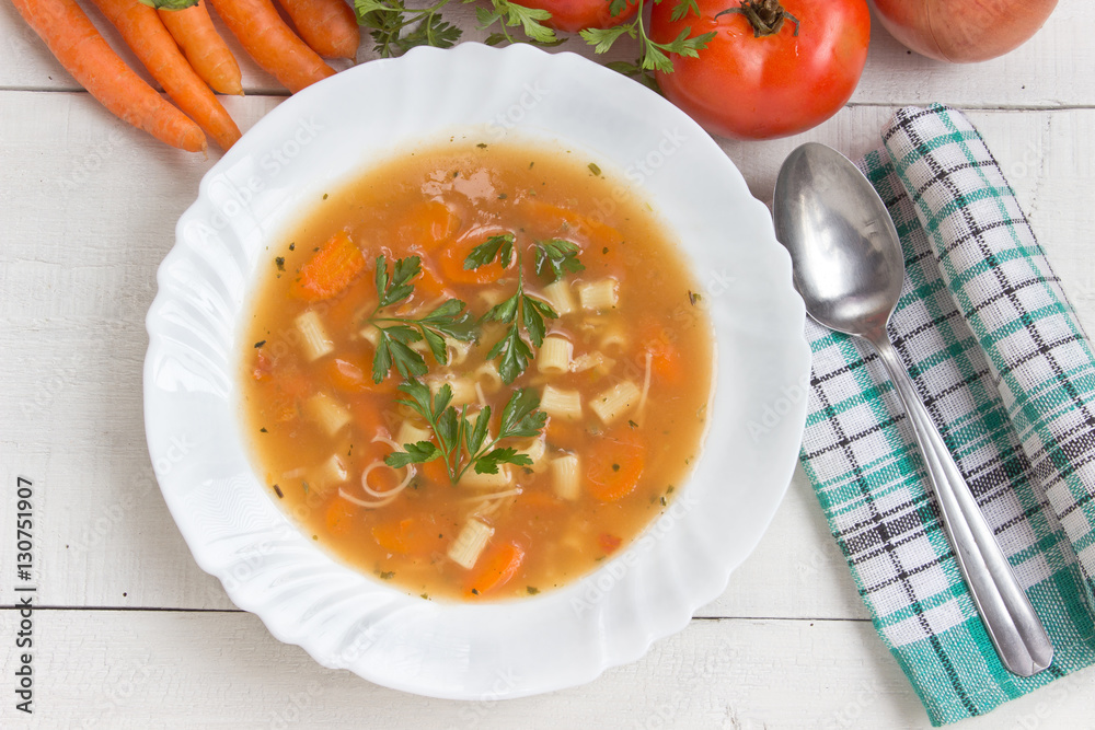 Minestrone soup in plate on white wooden table Minestrone soup in plate on white wooden table