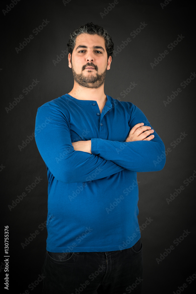 Handsome man doing different expressions in different sets of clothes: arms crossed Handsome man doing different expressions in different sets of clothes: arms crossed