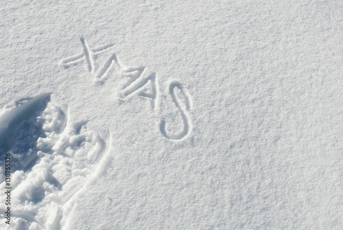 Scritta Xmas e impronta ciaspole da neve nella neve fresca delle montagne, Passo del Sempione, Alpi, Svizzera photo