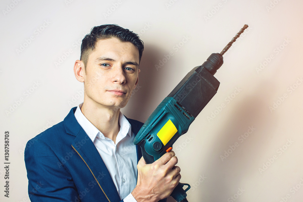 man businessman holds in hand a power drill as weapon man businessman holds in hand a power drill as weapon