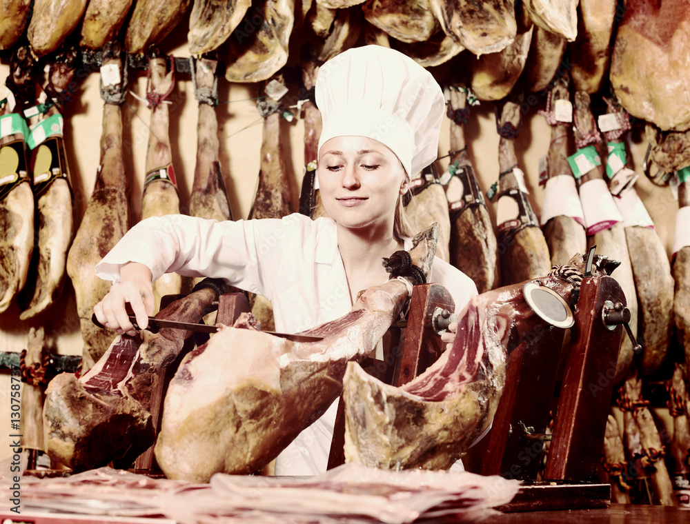 woman cutting dried ham