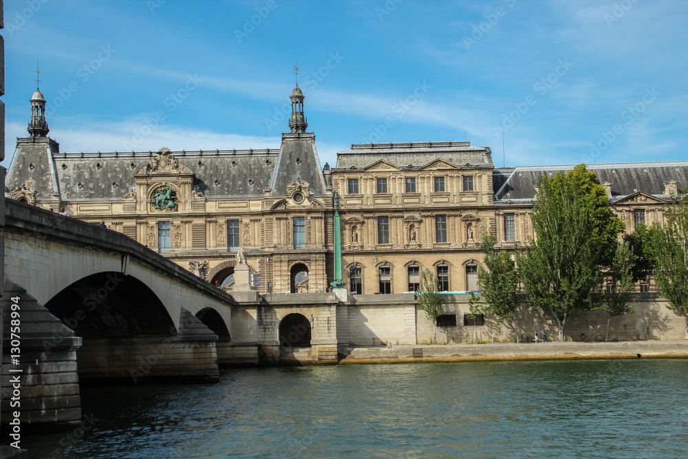 Royal bridge across the Seine river and Louvre museum
