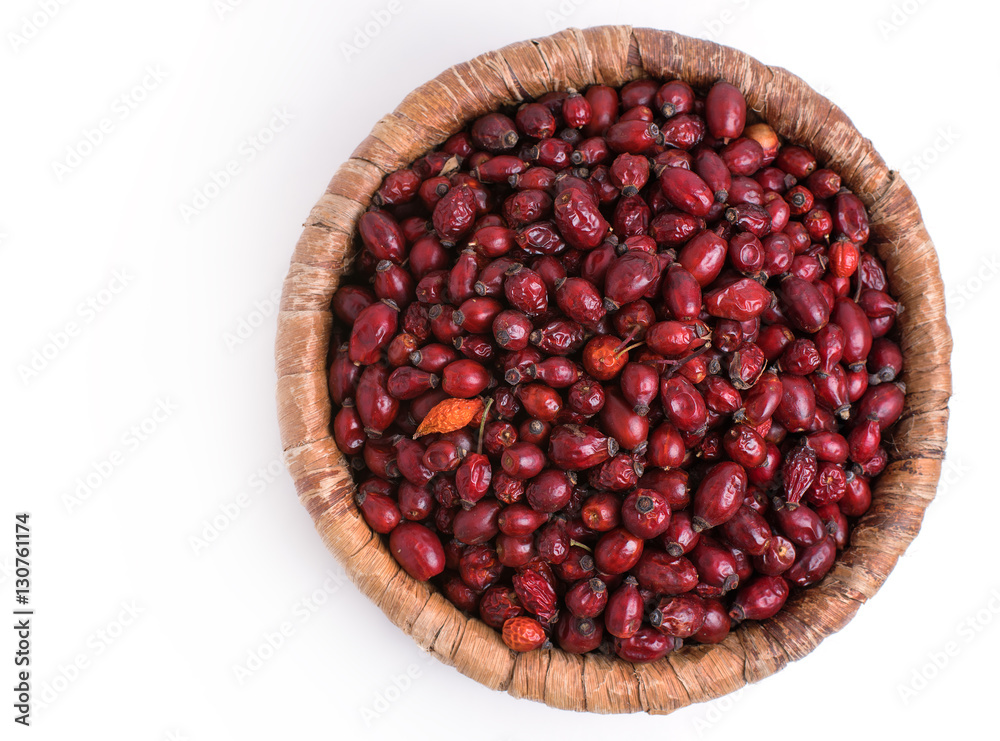 Dried rose hips in wicker basket isolated on white background Dried rose hips in wicker basket isolated on white background