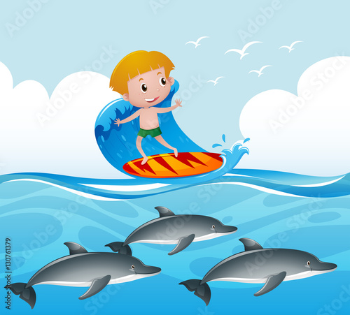 Scene with boy on surfboard and dolphin underwater