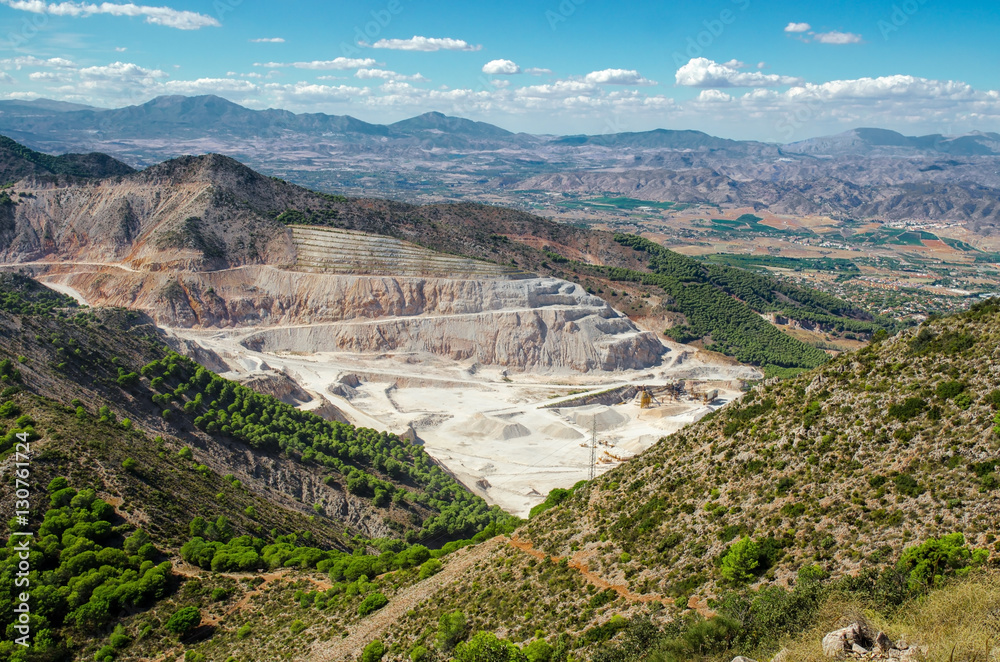 Overall view of limestone quarry near Calamorro mountain and Benalmadena town, provence Malaga, Andalusia, Southern Spain. Overall view of limestone quarry near Calamorro mountain and Benalmadena town, provence Malaga, Andalusia, Southern Spain.