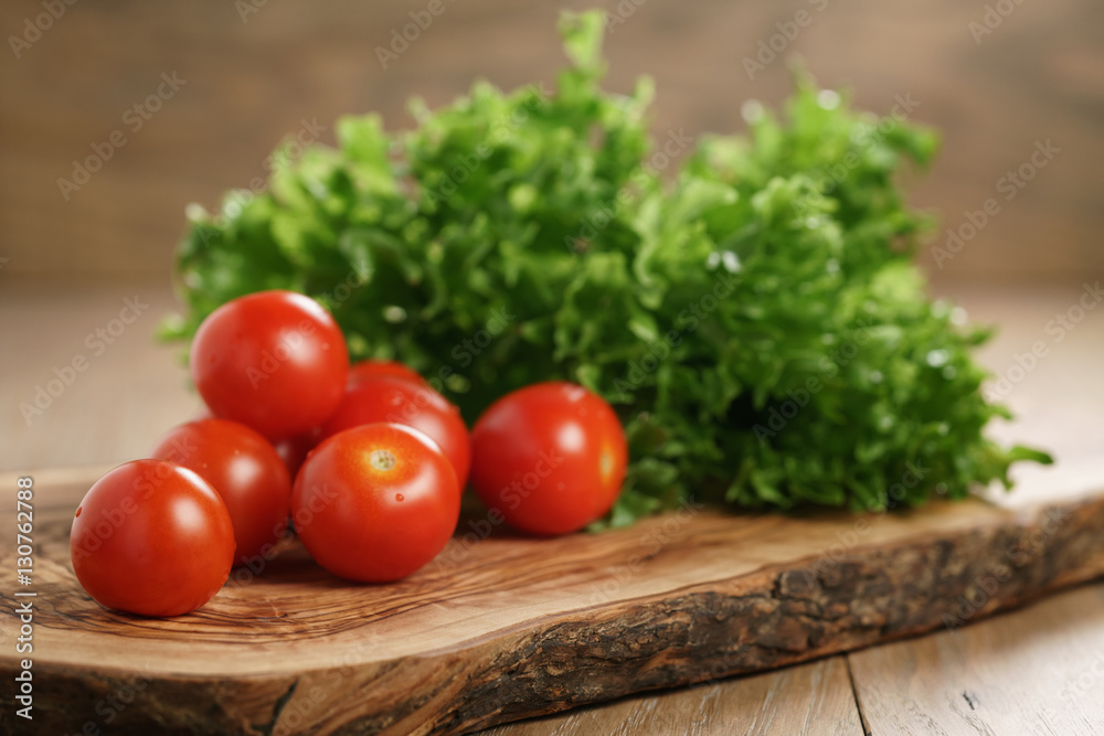 cherry tomatoes and frisee lettuce on cutting board cherry tomatoes and frisee lettuce on cutting board