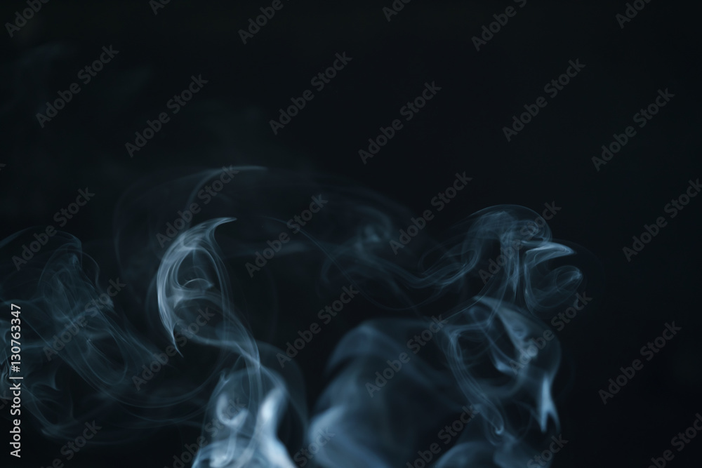 Fototapeta premium real blue smoke over black background