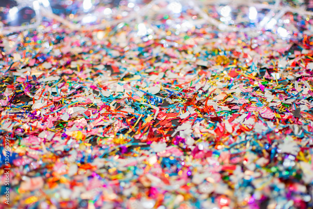 Closeup of colorful confetti and Christmas lights Closeup of colorful confetti and Christmas lights