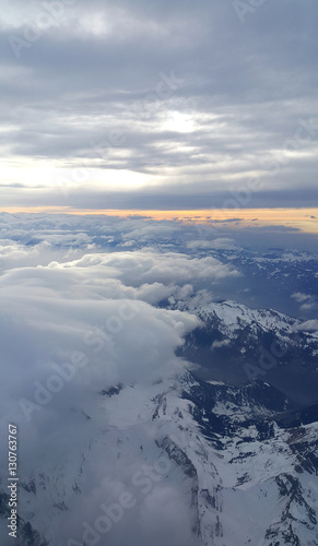 Top view on the Alps covered with snow and clouds